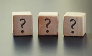 Three wooden cubes with a question mark